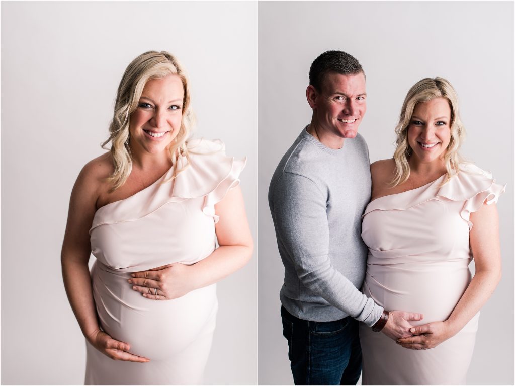 Studio Maternity session with Mom is pink gown and Dad both holding baby belly