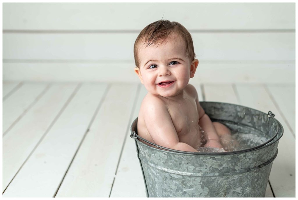 baby boy smiling in basin