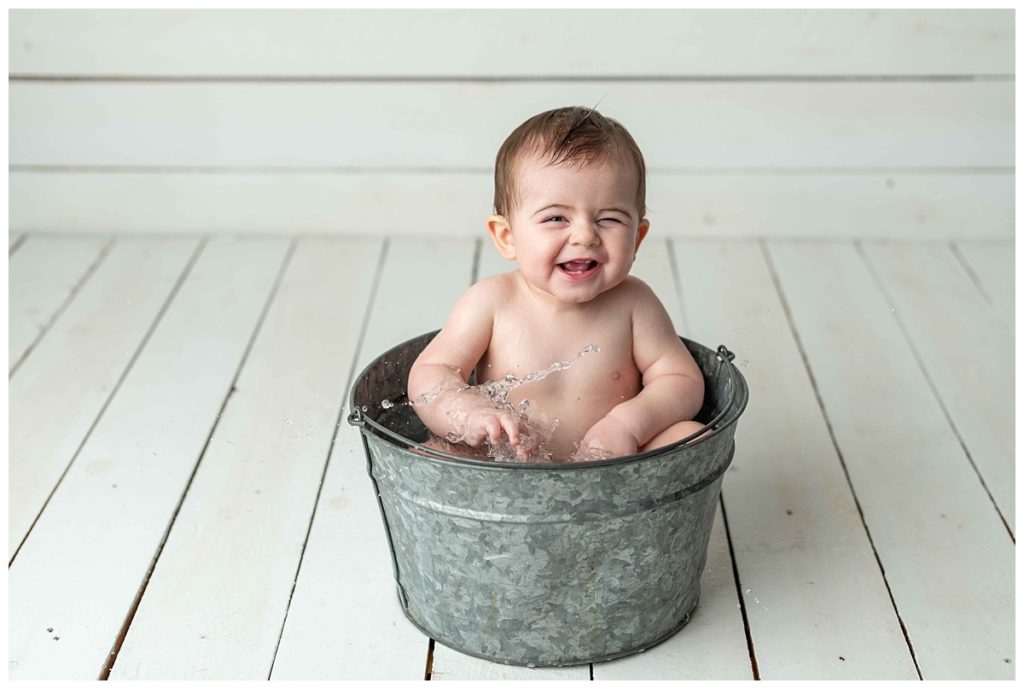 baby boy splashing in basin