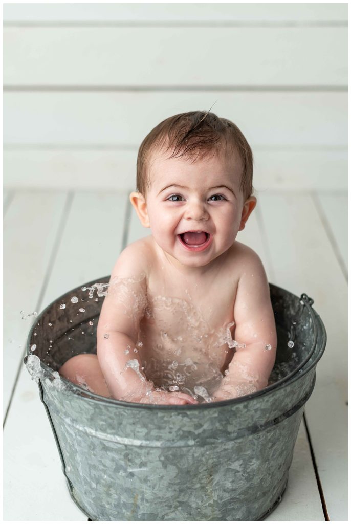 baby boy laughing in basin
