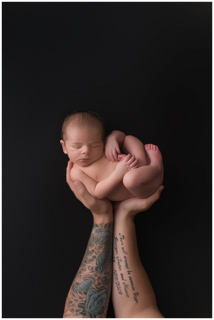 Dads tattoos arms holding baby boy
