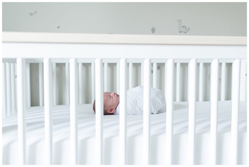 side view of baby in crib